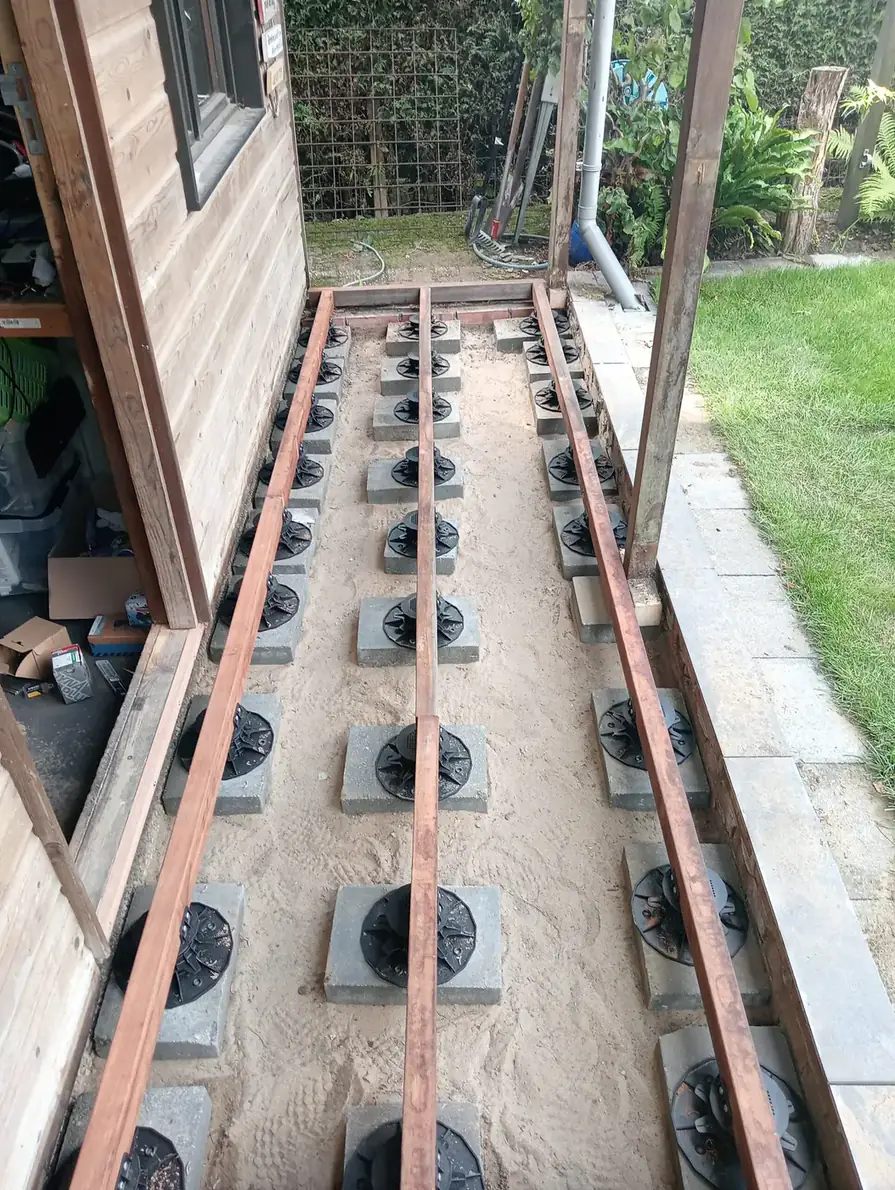 Hardwood decking around a log cabin, photo 1